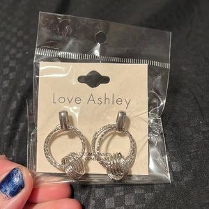 Silver toned double hoops with a celeltic knott.
